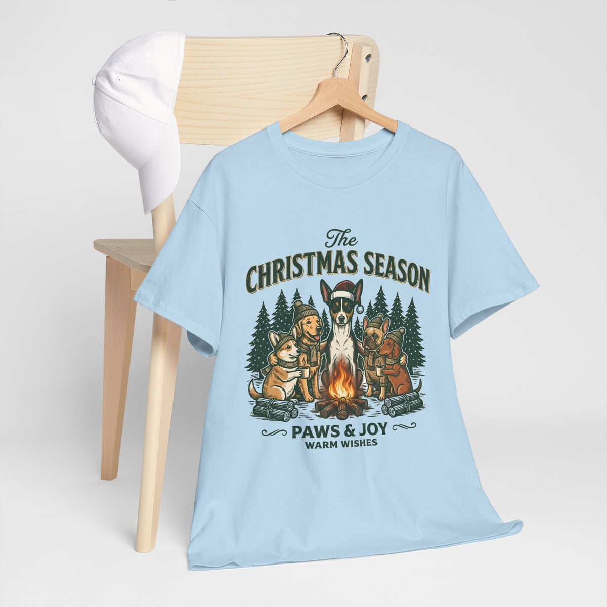 The Christmas Season Unisex T-Shirt — dogs settle in around a crackling campfire