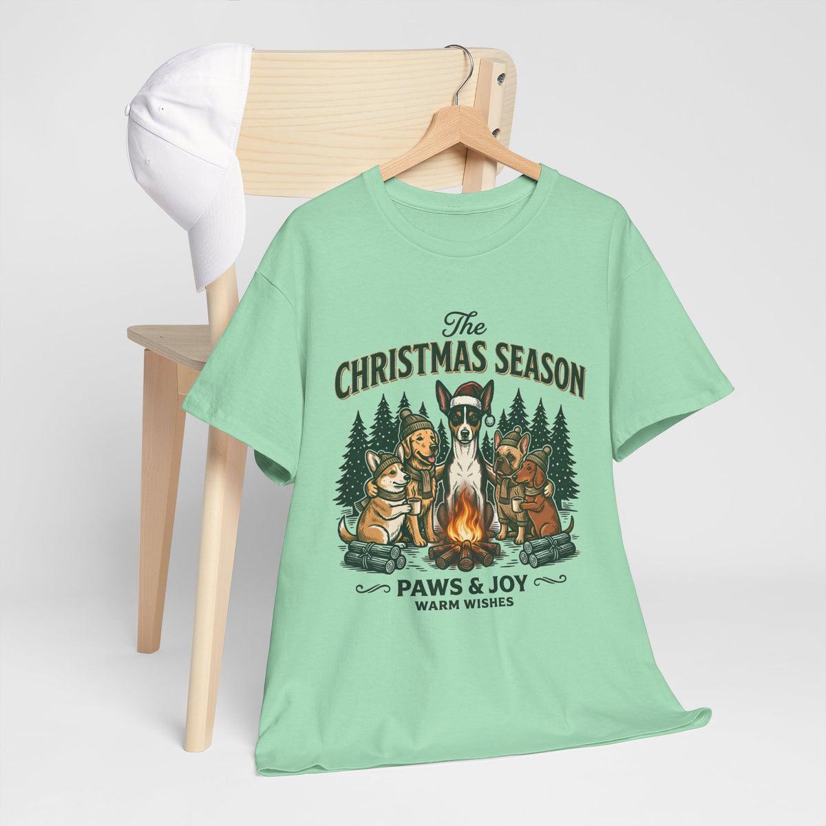 The Christmas Season Unisex T-Shirt — dogs settle in around a crackling campfire