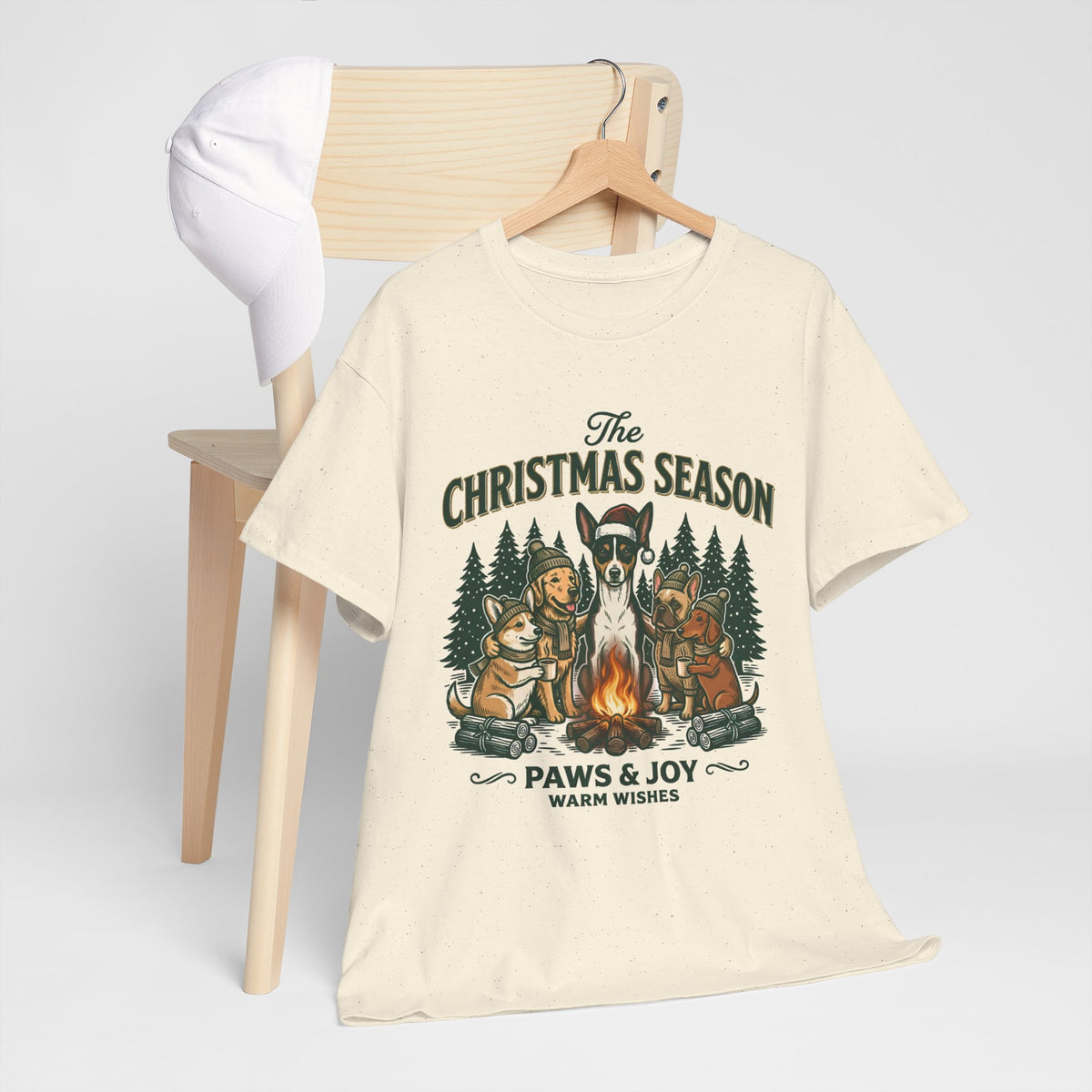 The Christmas Season Unisex T-Shirt — dogs settle in around a crackling campfire
