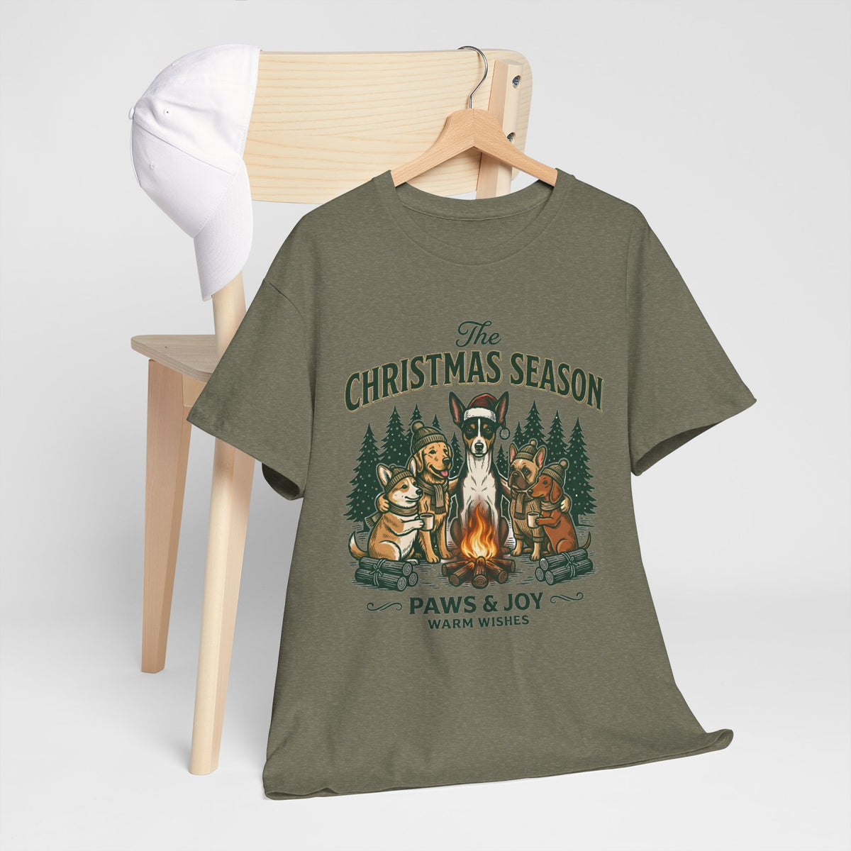 The Christmas Season Unisex T-Shirt — dogs settle in around a crackling campfire