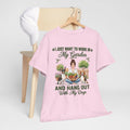 I Just Want to Work in My Garden and Hang Out With My Dogs Unisex T-Shirt — woman relaxes cross-legged in her garden